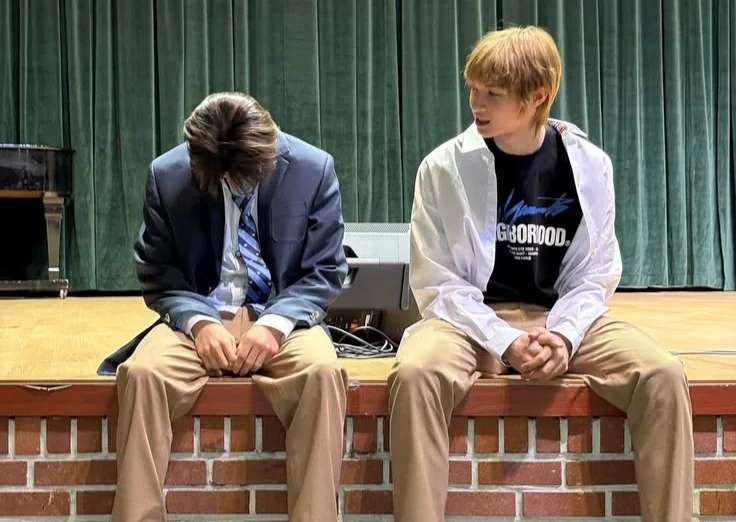 A photo together sitting on a stage